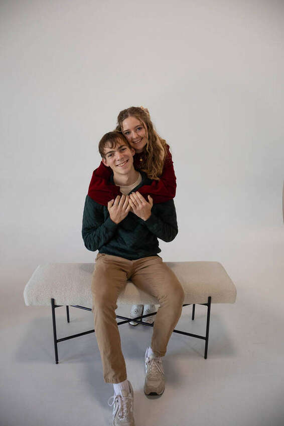 Couple in a studio session, she's hugging him from behind