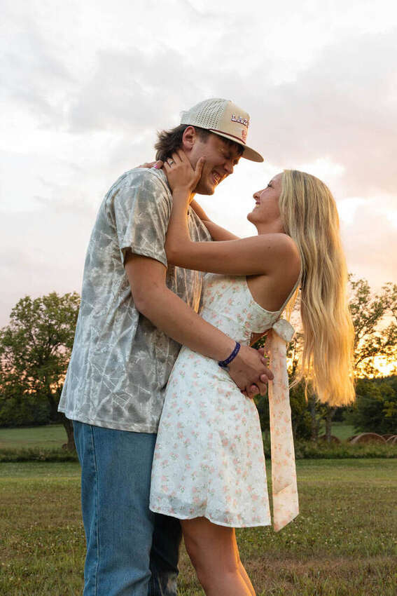 Couple embracing at sunset in a field