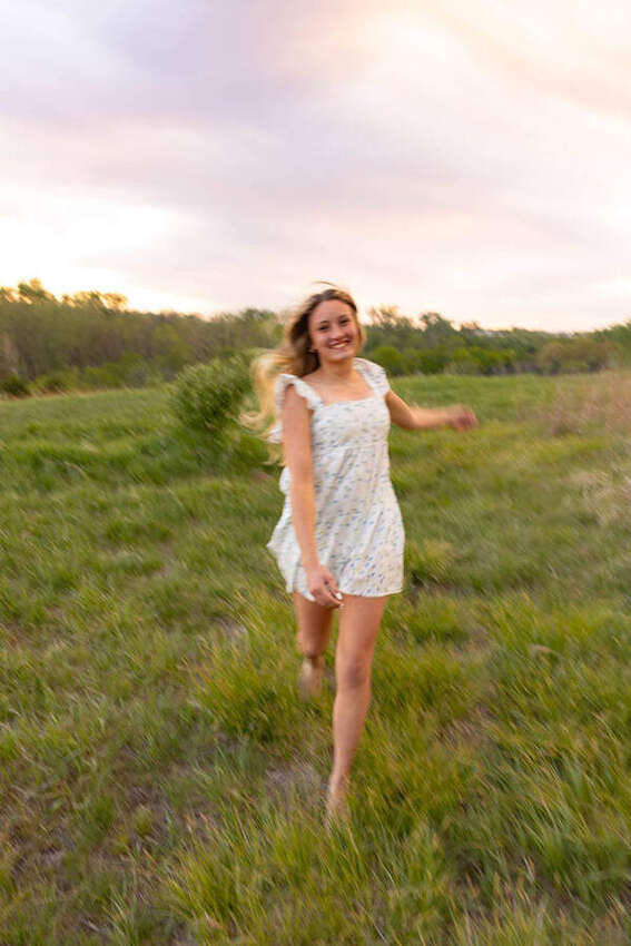 Senior girl running through a field