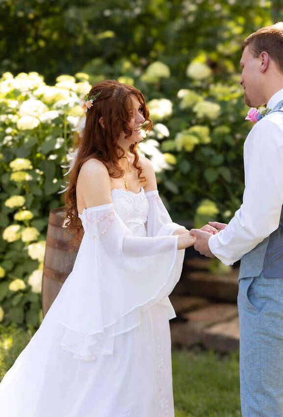 Bride and groom holding hands during their ceremony