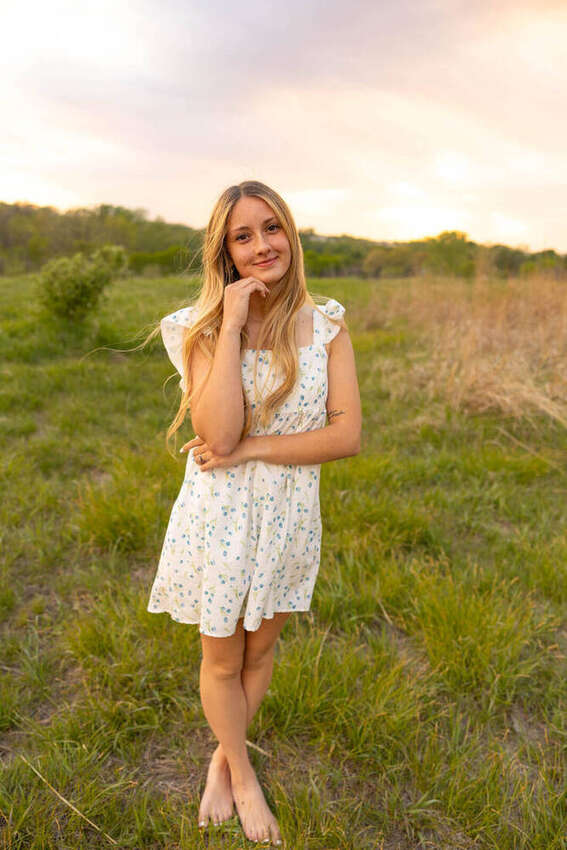 Portrait of a girl in a floral dress in a field