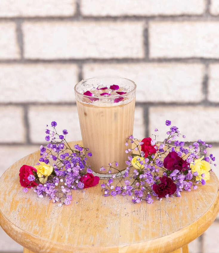 Styled iced latte with rose petals and flowers