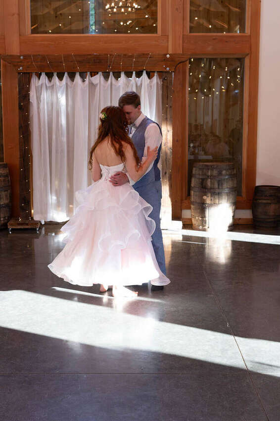 Bride and groom sharing a first dance indoors